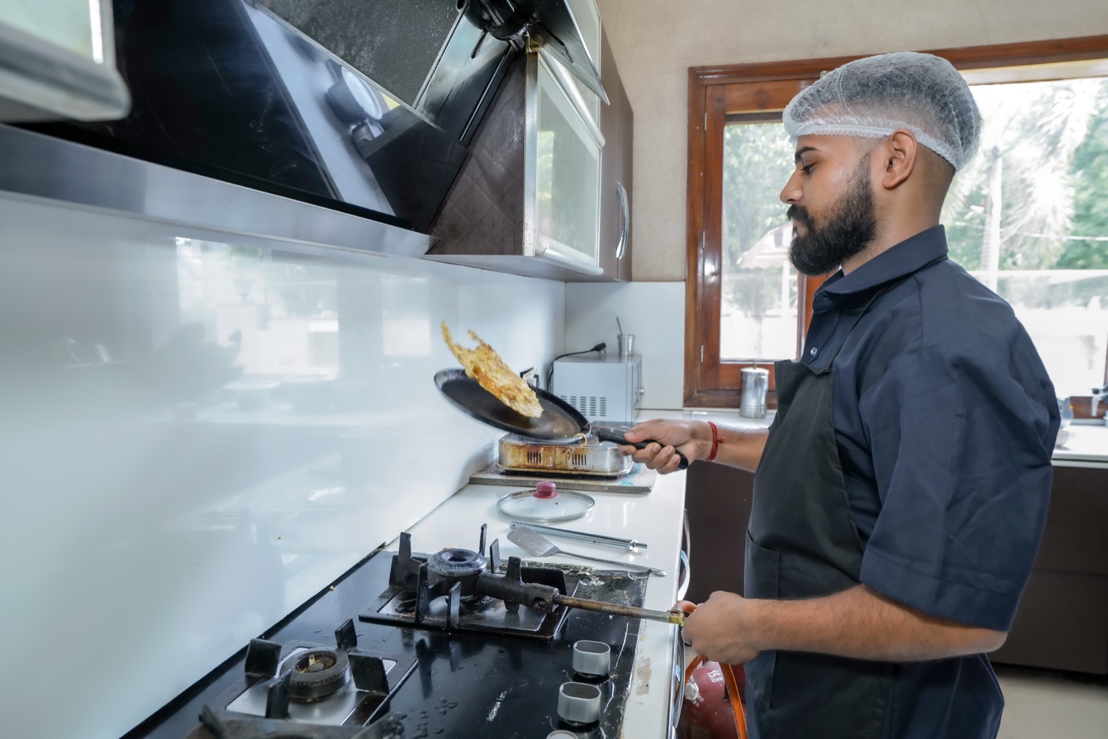 Our butler preparing fresh food at the stove