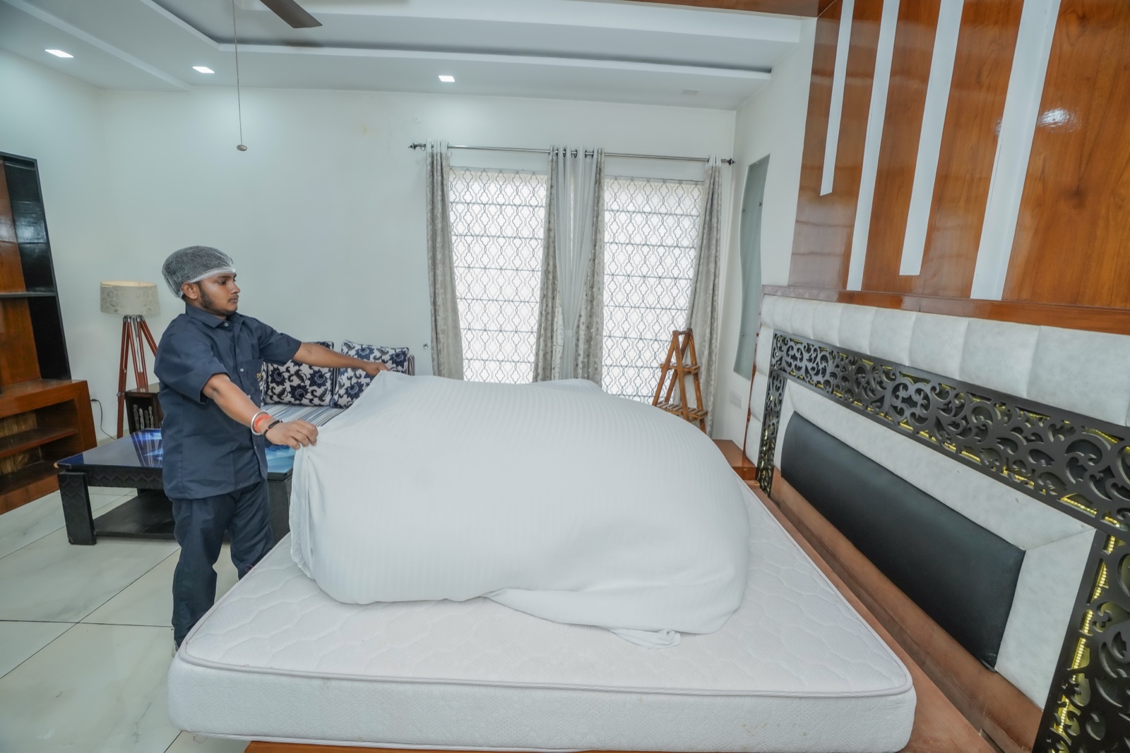 Our butler making a bed in a well-kept bedroom
